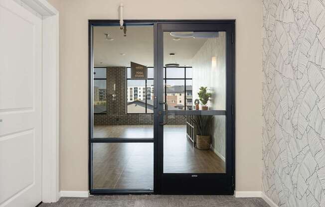 A black door with a glass window is open.