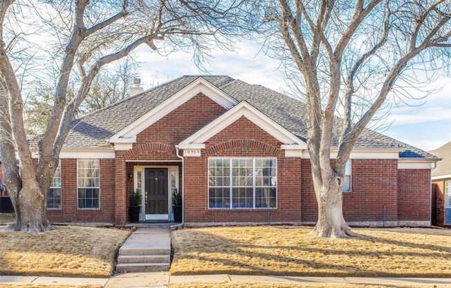 This charming 3-bedroom, 2-bath home in Frisco, TX, boasts elegant hardwood floors throughout, enhancing its warm and inviting atmosphere.