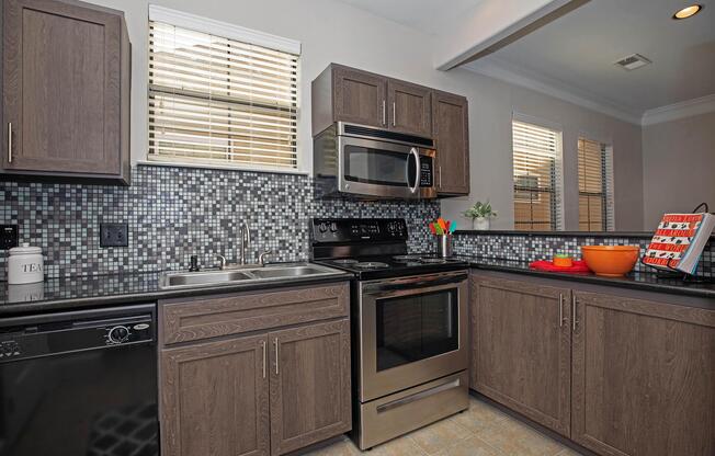 a kitchen with stainless steel appliances and wooden cabinets