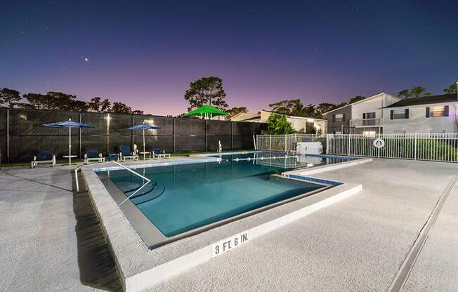 Community Swimming Pool with Pool Furniture at Arbors at Orange Park Apartments located in Orange Park, FL.