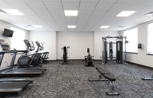 a room filled with lots of cardio equipment and weights