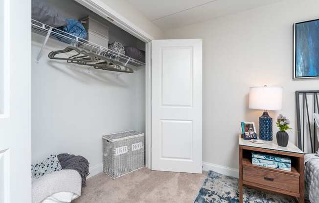a bedroom with a closet and a desk with a lamp