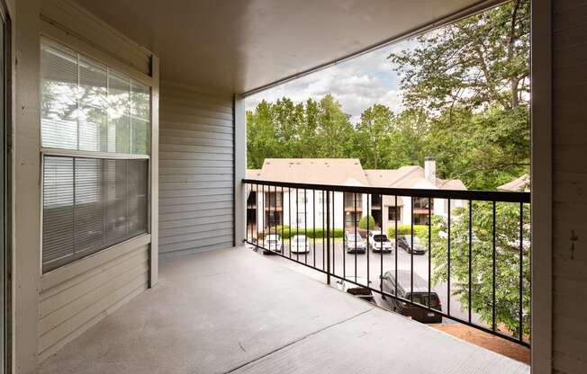 the view from the balcony of a home with a large screen porch