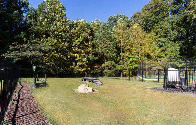 a fenced in area with a picnic table and a bench
