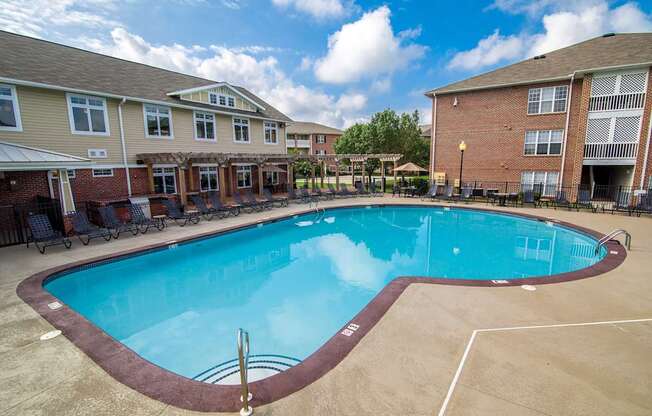 A swimming pool in a residential area surrounded by houses.