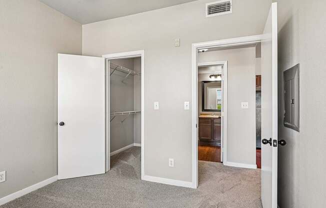A room with a carpeted floor and a white door.