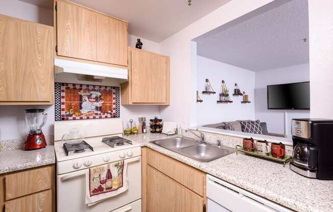 a kitchen with white appliances and granite counter tops