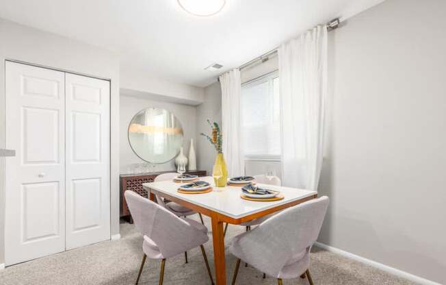 A dining room with a table set for two.