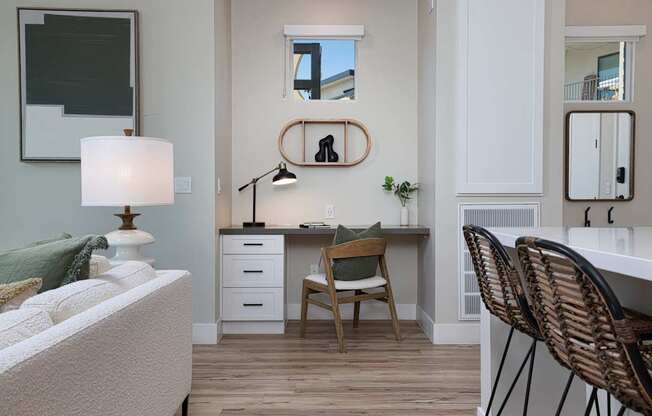 A room with a desk, chair, and a bed.