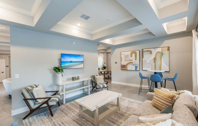 a living room with a tv, a couch and coffee table