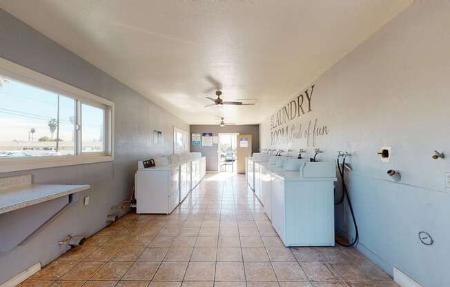 Apartments in Colton CA for Rent - Las Brisas Apartments Laundry Room with Washing Machines, Dryers, and A Folding Station
