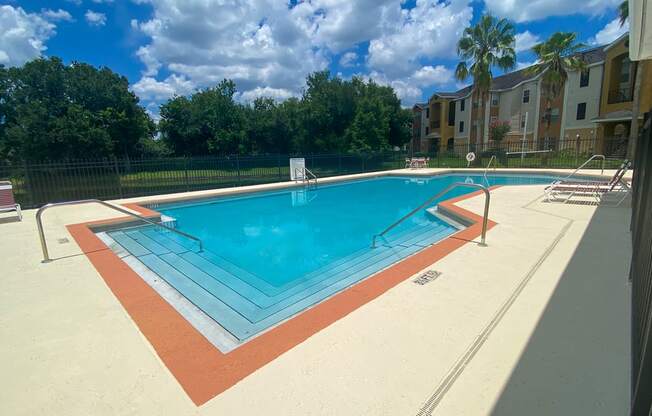 a swimming pool at an apartment building with a pool