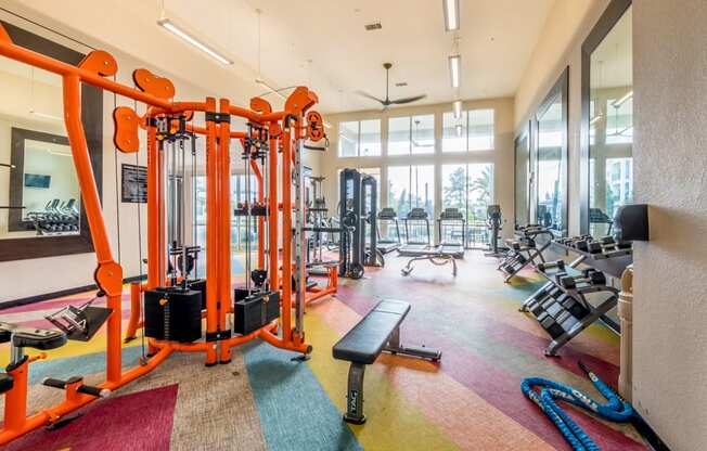 a gym with cardio machines and other equipment in the lobby of a building