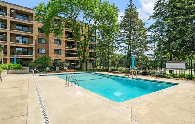 our apartments have a swimming pool and a building with trees