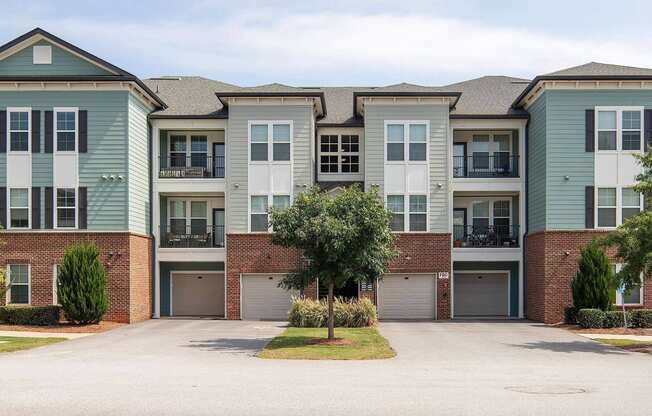 an exterior view of an apartment building with a driveway