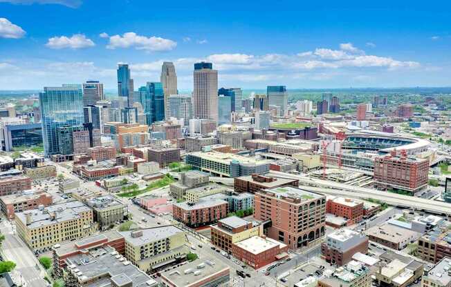 A cityscape with a mix of modern and older buildings under a clear sky.