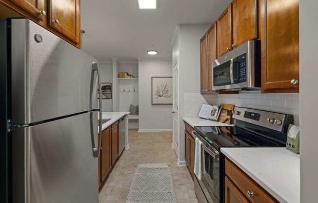 a kitchen with stainless steel appliances and wooden cabinets