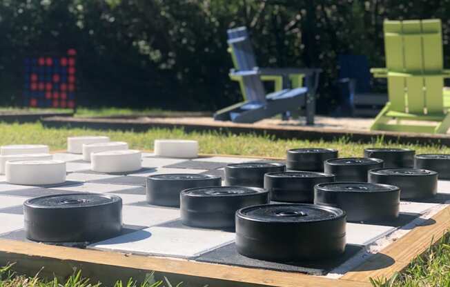 a chess board in the grass with tires on it