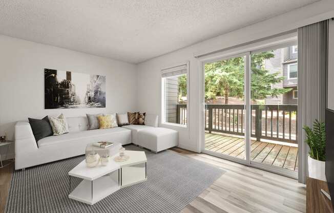 Living room with a white couch and a sliding glass door at Larkspur West Linn, Oregon, 97068