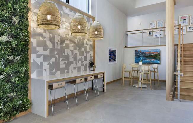 A room with a green wall on the left and a table with chairs in the center.