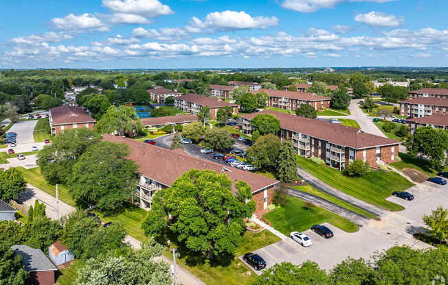 A bird's eye view of a residential area with houses and cars.