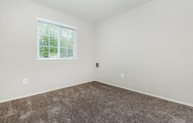 a bedroom with a large window