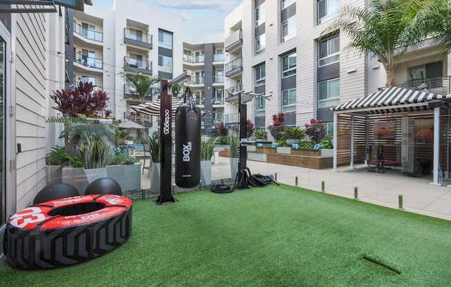 A black and red tire with the number 3 on it sits on a green artificial turf.