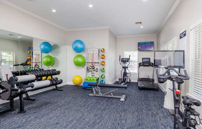 a workout room at the enclave at woodbridge apartments in sugar land, tx