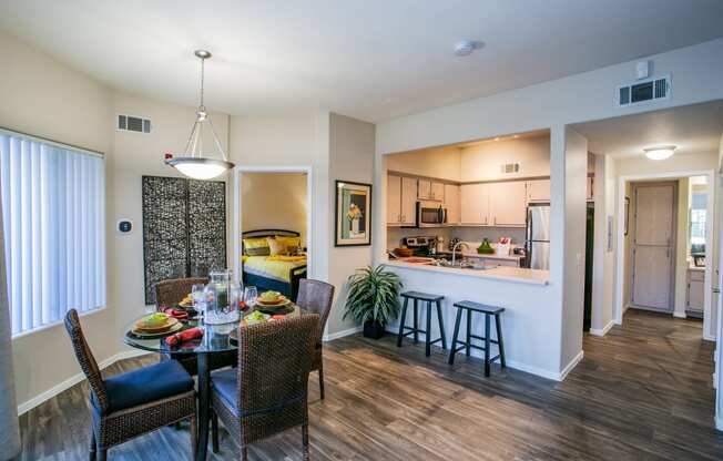 a dining room and kitchen area with a table and chairs in apartment in Las Vegas Nevada