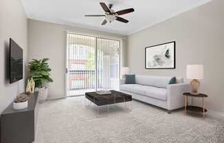 A living room with a white couch, a grey cabinet, a coffee table, and a ceiling fan.