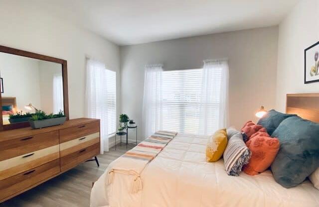 bedroom with a bed and a dresser at Mainstreet Apartments, Clearwater
