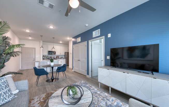 a living room with a tv and a table with chairs