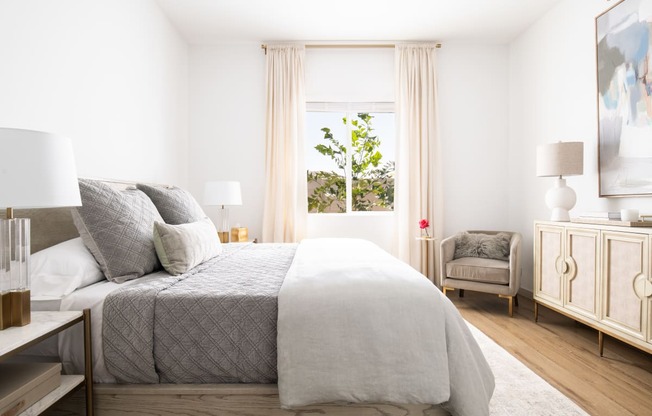 a bedroom with a bed and a window