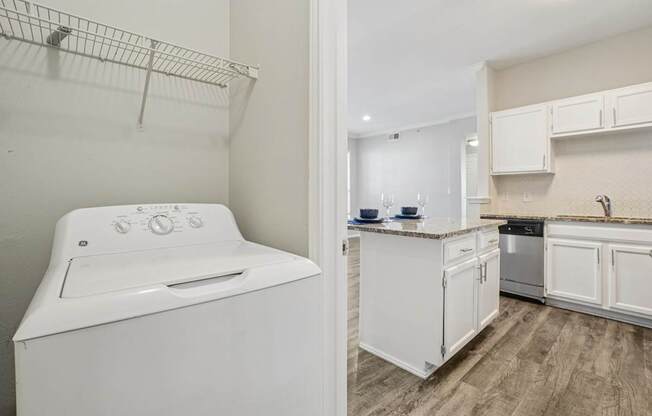 A white washing machine in a laundry room.