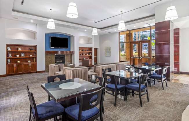 A dining room with a table set for six people.
