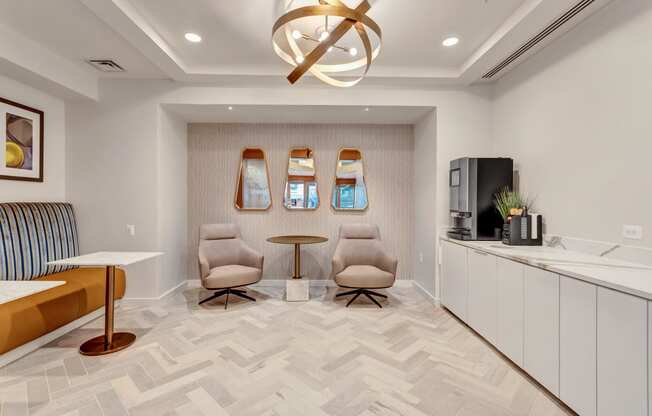 a living room with two chairs and a table and a ceiling fan