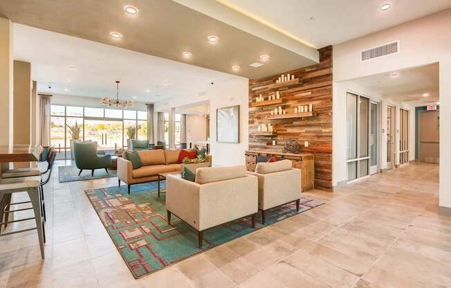 A living room with a couch, chairs, and a rug.
