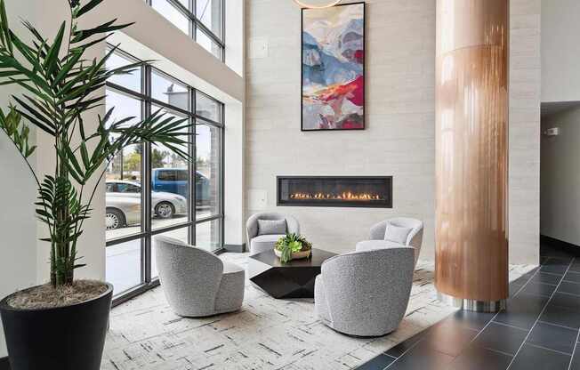 A modern waiting area with a large painting on the wall and comfortable seating.