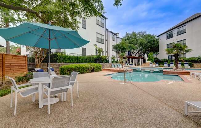 our apartments have a pool and patio with chairs and umbrellas