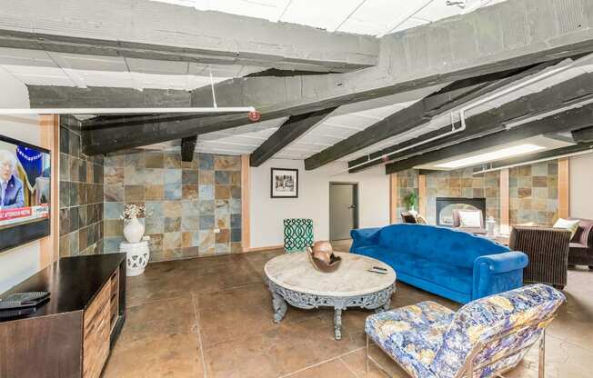 a living room with a blue couch and a table