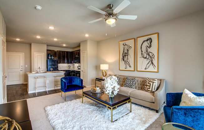 a living room with a ceiling fan and a white rug
