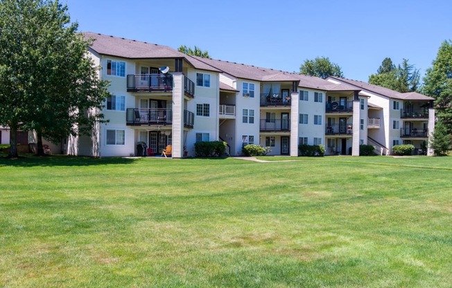 a large lawn in front of an apartment building