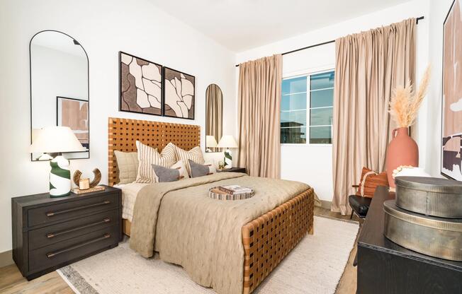 A spacious primary bedroom with wood-style flooring, ceiling fan, and generous natural light for a comfortable, everyday retreat.