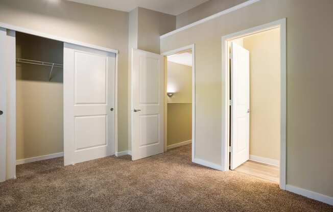 Bedroom with closet and two doors at Arcadia Townhomes, Federal Way, WA