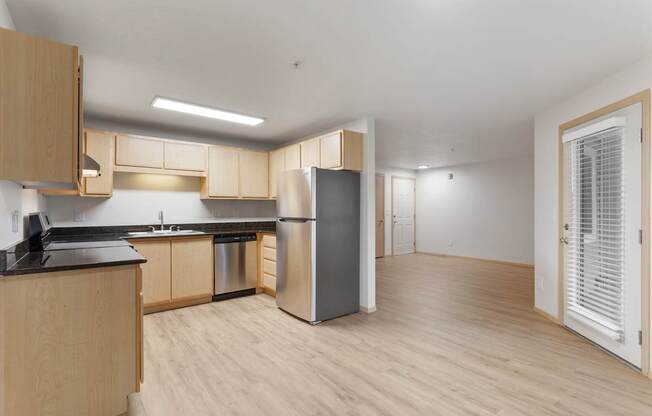 A kitchen with wooden cabinets and a black countertop.