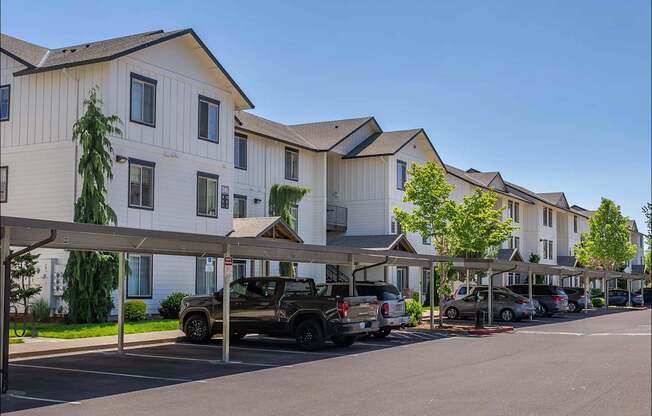 A row of houses with cars parked in front at Riverplace Apartment Homes, Independence, OR