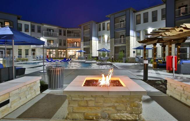an outdoor area with a fire pit at night