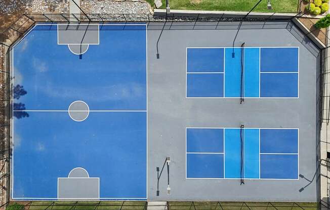 A tennis court with blue surface and white lines.