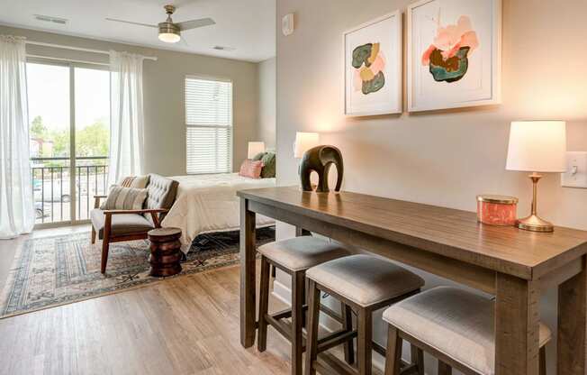 a living room and dining room with a table and chairs