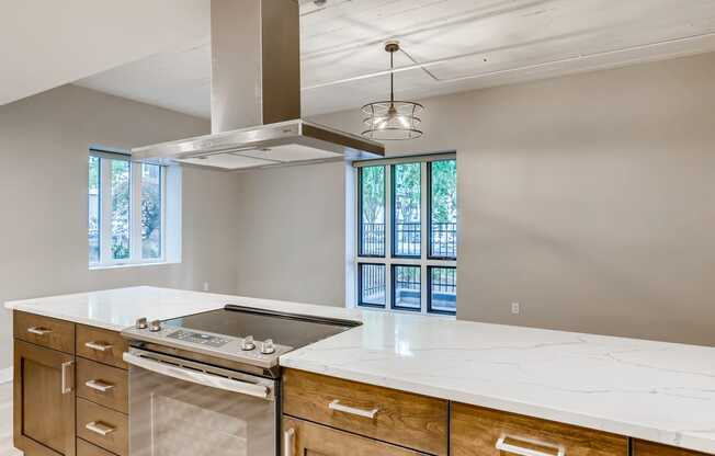 an empty kitchen with an island and a stove